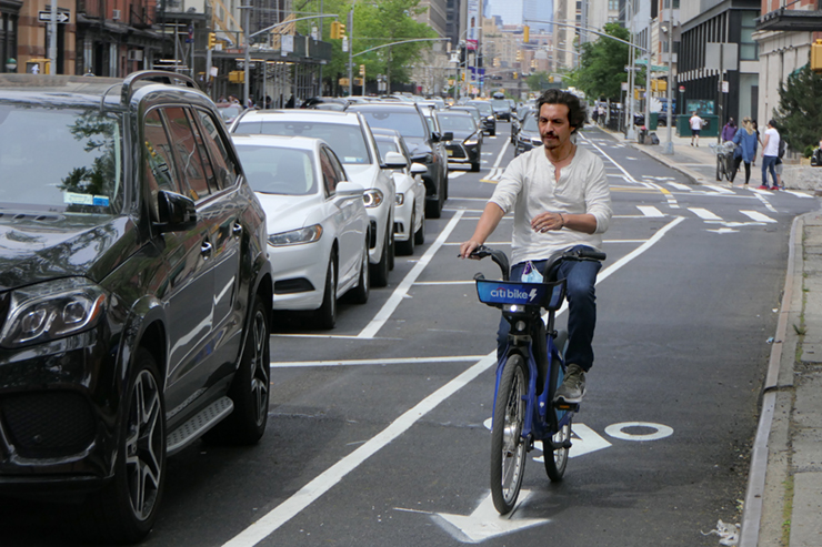 Cyclists can now ride down Varick Street to West Broadway along a bike lane separated from traffic by a parking lane. The West Broadway lane is partially completed. A similar lay out is coming to Sixth Avenue, beginning at Franklin Street. Photo: Carl Glassman/Tribeca Trib